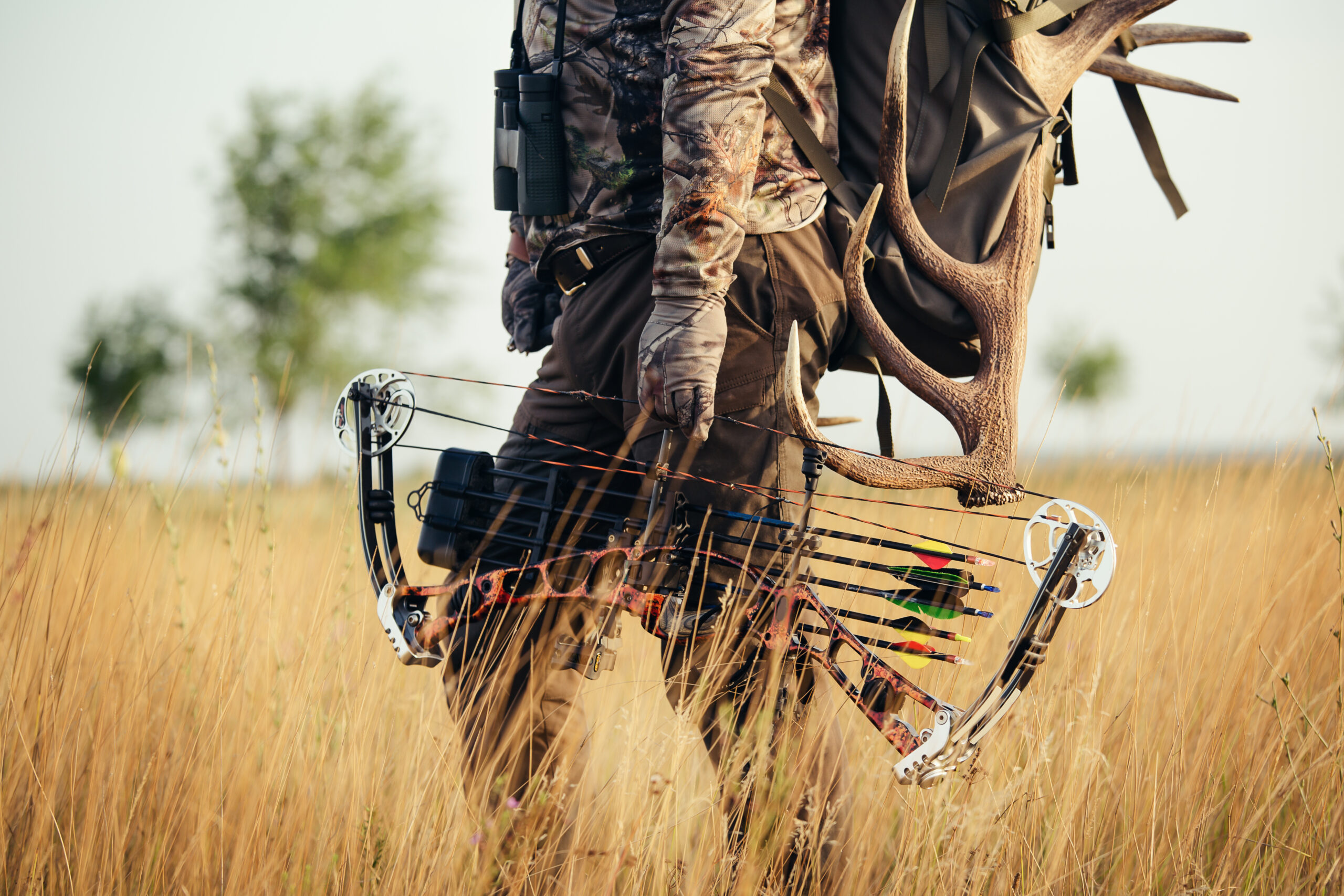 Close up view of a bow hunter in a field. Successful Bow Hunters Share These Top 3 Traits